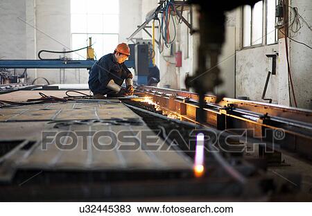 "Worker using equipment in crane manufacturing facility, China" View Large Photo Image Stock Image - "Worker using equipment in crane manufacturing facility, China". Fotosearch