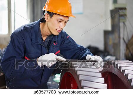 "Worker using equipment in crane manufacturing facility, China" View Large Photo Image Stock Image - "Worker using equipment in crane manufacturing facility, China". Fotosearch
