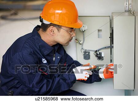 "Worker working on fuse box in crane manufacturing facility, China" View Large Photo Image Stock Photo - "Worker working on fuse box in crane manufacturing facility, China". Fotosearch