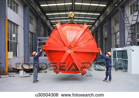 "Workers working together in crane manufacturing facility, China" View Large Photo Image Stock Photo - "Workers working together in crane manufacturing facility, China". Fotosearch