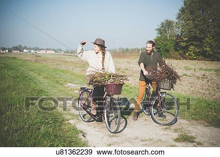 "Young couple cycling in countryside, Dolo, Venice, Italy" View Large Photo Image Stock Photo - "Young couple cycling in countryside, Dolo, Venice, Italy". Fotosearch
