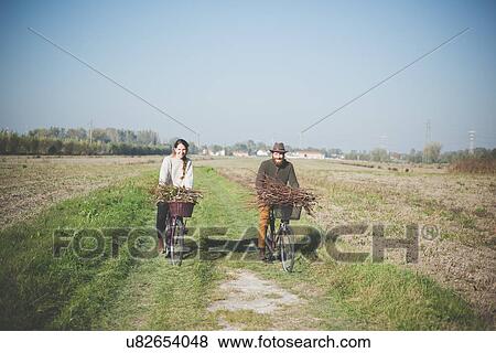 "Young couple cycling in countryside, Dolo, Venice, Italy" View Large Photo Image Stock Photo - "Young couple cycling in countryside, Dolo, Venice, Italy". Fotosearch