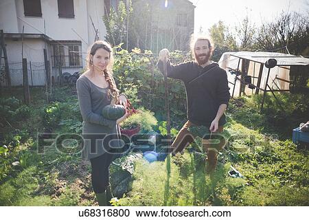 "Young couple gardening, portrait" View Large Photo Image Stock Image - "Young couple gardening, portrait". Fotosearch
