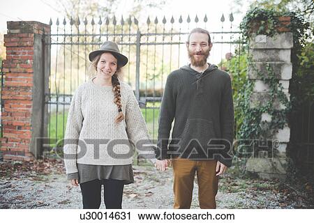 "Young couple holding hands, portrait" View Large Photo Image Stock Image - "Young couple holding hands, portrait". Fotosearch