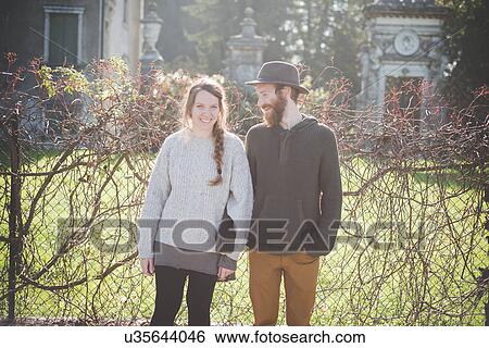 "Young couple side by side, portrait" View Large Photo Image Stock Photograph - "Young couple side by side, portrait". Fotosearch