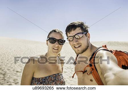 "Young couple taking selfie, Dune de Pilat, France" View Large Photo Image Stock Photography - "Young couple taking selfie, Dune de Pilat, France". Fotosearch
