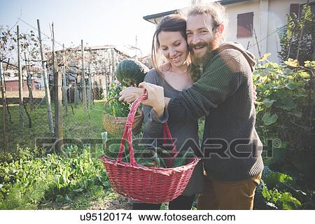 Young couple with basket of homegrown vegetables View Large Photo Image Picture - Young couple with basket of homegrown vegetables. Fotosearch