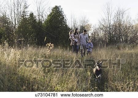 Young couple with son and daughter walking the dog View Large Photo Image Stock Image - Young couple with son and daughter walking the dog. Fotosearch