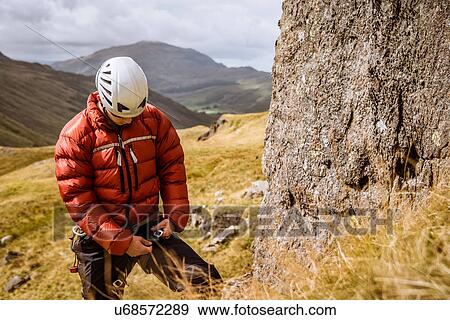 "Young male climber fastening rope, The Lake District, Cumbria, UK" View Large Photo Image Stock Photo - "Young male climber fastening rope, The Lake District, Cumbria, UK". Fotosearch