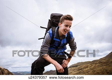 "Young male hiker reaching top of mountain, The Lake District, Cumbria, UK" View Large Photo Image Stock Photo - "Young male hiker reaching top of mountain, The Lake District, Cumbria, UK". Fotosearch