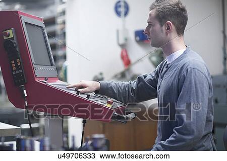 Young male technician using control panel in workshop View Large Photo Image Stock Image - Young male technician using control panel in workshop. Fotosearch