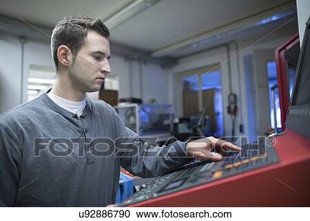 Young male technician using control panel for machine in workshop View Large Photo Image Stock Image - Young male technician using control panel for machine in workshop. Fotosearch