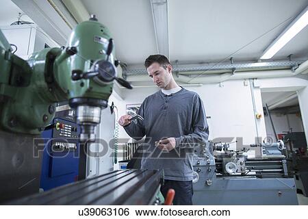 Young male technician using vernier caliper in workshop View Large Photo Image Stock Photograph - Young male technician using vernier caliper in workshop. Fotosearch