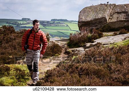 "Young man hiking on crocodile rock, Pateley Bridge, Nidderdale, Yorkshire Dales" View Large Photo Image Stock Photo - "Young man hiking on crocodile rock, Pateley Bridge, Nidderdale, Yorkshire Dales". Fotosearch