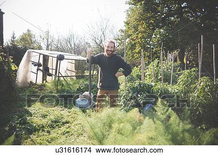 "Young man in garden, portrait" View Large Photo Image Picture - "Young man in garden, portrait". Fotosearch