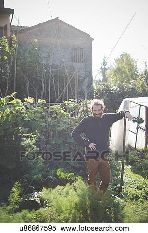 "Young man in garden, portrait" View Large Photo Image Stock Photography - "Young man in garden, portrait". Fotosearch