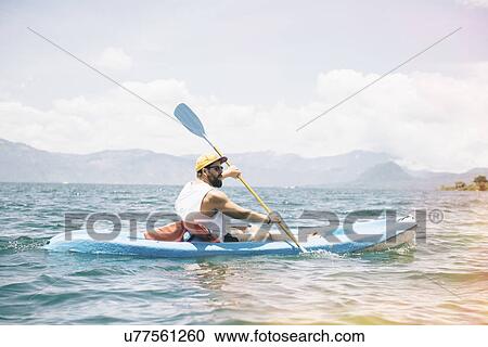 "Young man kayaking on Lake Atitlan, Guatemala" View Large Photo Image Stock Image - "Young man kayaking on Lake Atitlan, Guatemala". Fotosearch