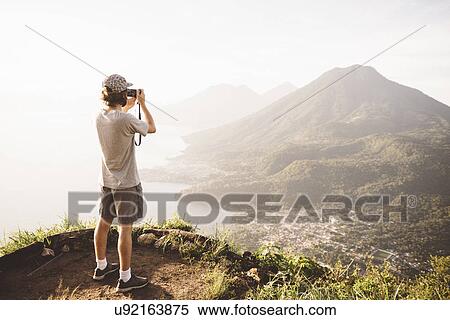 "Young man photographing at Lake Atitlan on digital camera, Guatemala" View Large Photo Image Stock Photography - "Young man photographing at Lake Atitlan on digital camera, Guatemala". Fotosearch