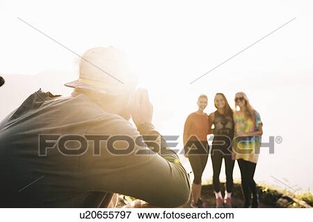 "Young man photographing female friends at Lake Atitlan on digital camera, Guatemala" View Large Photo Image Stock Photo - "Young man photographing female friends at Lake Atitlan on digital camera, Guatemala". Fotosearch