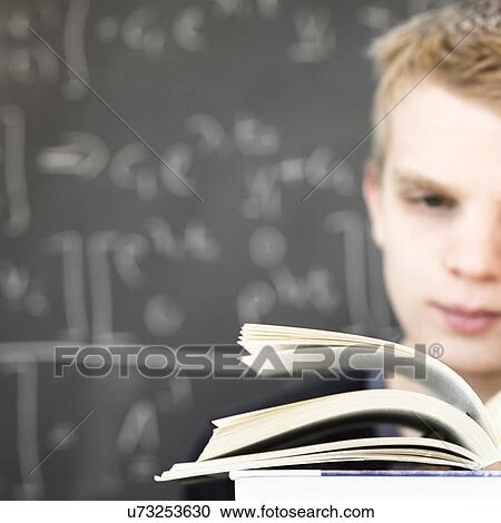 Young man reading Maths book View Large Photo Image Stock Image - Young man reading Maths book. Fotosearch