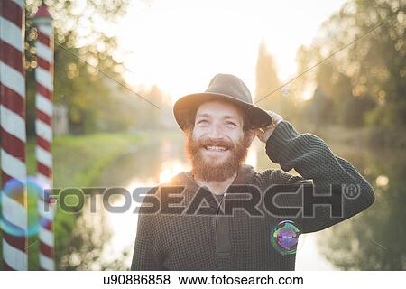 Stock Photo - "Young man wearing hat, smiling". Fotosearch