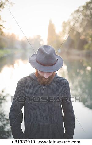 Stock Image - Young man wearing hat. Fotosearch