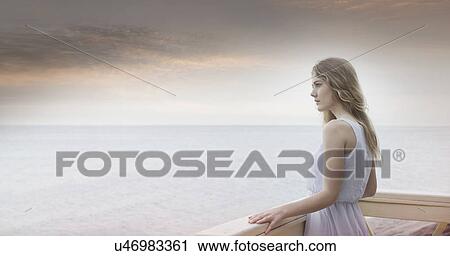 "Young woman gazing out to sea from balcony, Miami Beach, Florida, USA" View Large Photo Image Stock Image - "Young woman gazing out to sea from balcony, Miami Beach, Florida, USA". Fotosearch