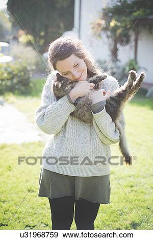 Young woman hugging cat View Large Photo Image Stock Photo - Young woman hugging cat. Fotosearch