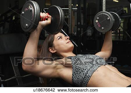 "Young woman, lifting weights" View Large Photo Image Stock Image - "Young woman, lifting weights". Fotosearch