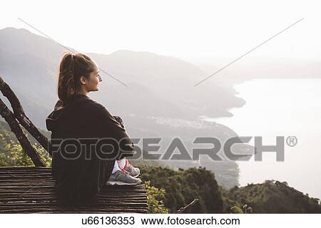 "Young woman on balcony looking out over Lake Atitlan, Guatemala" View Large Photo Image Stock Image - "Young woman on balcony looking out over Lake Atitlan, Guatemala". Fotosearch