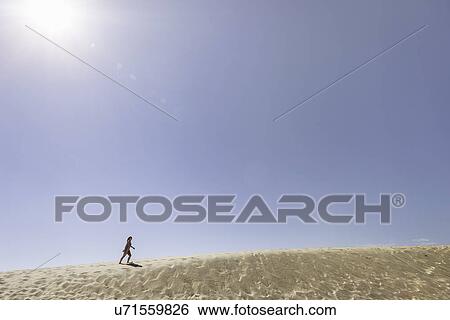 "Young woman running up Dune de Pilat, France" View Large Photo Image Stock Photograph - "Young woman running up Dune de Pilat, France". Fotosearch