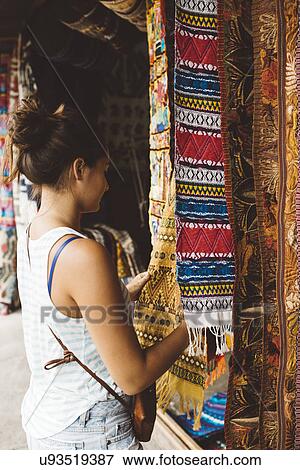 "Young woman shopping for textiles at market stall, Lake Atitlan, Guatemala" View Large Photo Image Stock Photo - "Young woman shopping for textiles at market stall, Lake Atitlan, Guatemala". Fotosearch