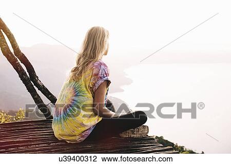 "Young woman sitting on balcony looking out over Lake Atitlan, Guatemala" View Large Photo Image Stock Image - "Young woman sitting on balcony looking out over Lake Atitlan, Guatemala". Fotosearch