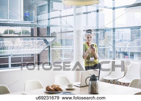 Young woman using smartphone in meeting room View Large Photo Image Stock Photo - Young woman using smartphone in meeting room. Fotosearch
