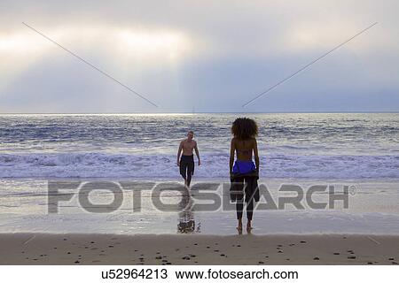 "Young woman waiting for surfing boyfriend on beach, Playa Del Rey, California, USA" View Large Photo Image Stock Image - "Young woman waiting for surfing boyfriend on beach, Playa Del Rey, California, USA". Fotosearch
