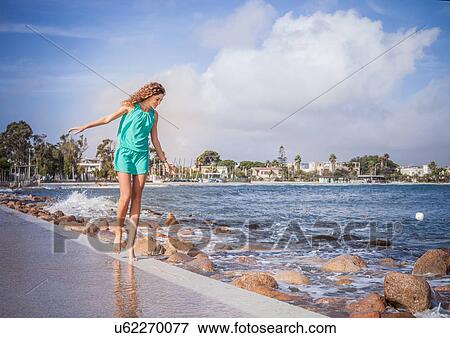 Young woman walking barefoot on promenade View Large Photo Image Stock Photo - Young woman walking barefoot on promenade. Fotosearch