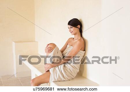 Young woman wrapped in a towel in sauna at spa View Large Photo Image Stock Image - Young woman wrapped in a towel in sauna at spa. Fotosearch