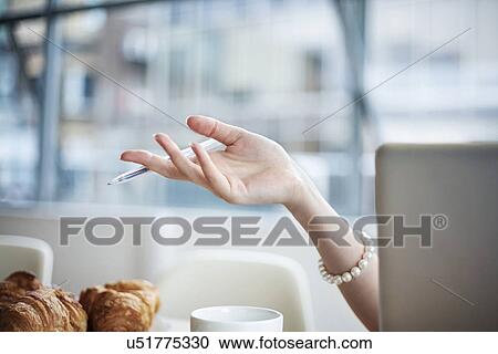 Young woman's hand seen behind laptop View Large Photo Image Stock Image - Young woman's hand seen behind laptop. Fotosearch