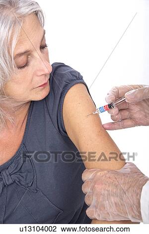Mature woman receiving vaccination View Large Photo Image Stock Image - Mature woman receiving vaccination. Fotosearch