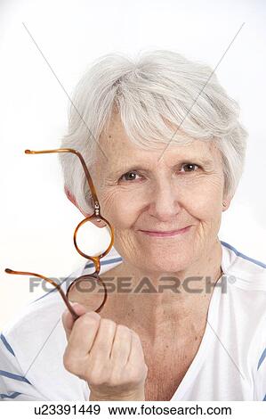 Stock Photo - Woman holding glasses. Fotosearch