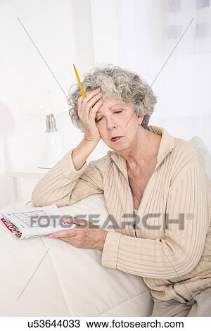 Woman holding puzzle book with hand on h View Large Photo Image Stock Image - Woman holding puzzle book with hand on h. Fotosearch