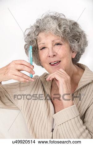 Picture - Woman holding smartphone. Fotosearch
