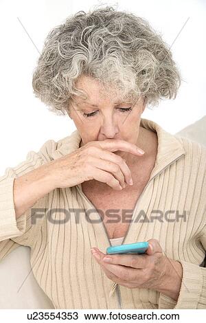 Stock Image - Woman holding smartphone. Fotosearch