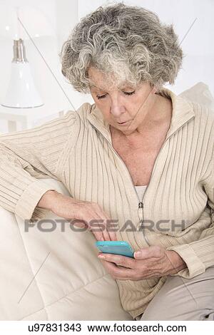 Woman holding smartphone View Large Photo Image Stock Image - Woman holding smartphone. Fotosearch