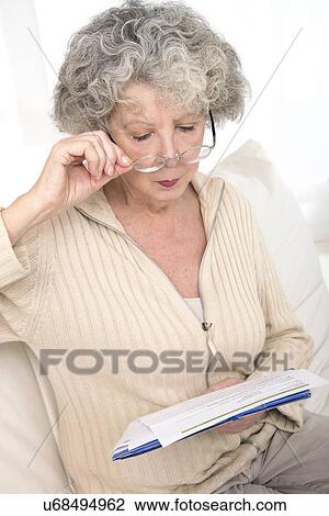 Stock Image - Woman reading a document. Fotosearch