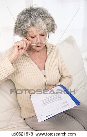 Stock Photo - Woman reading a document. Fotosearch