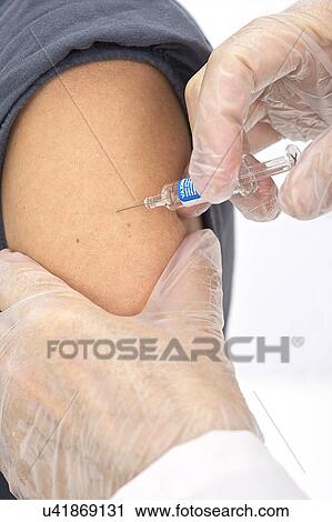 Stock Image - Woman receiving vaccination. Fotosearch