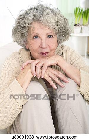 Stock Photo - Woman resting chin on hands. Fotosearch
