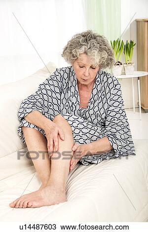 Woman touching her legs View Large Photo Image Stock Image - Woman touching her legs. Fotosearch