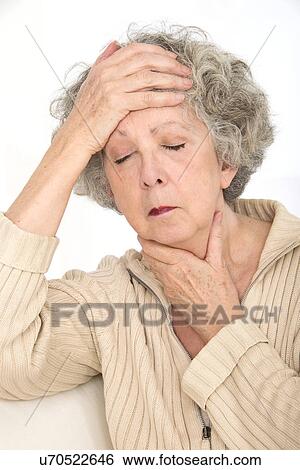 Stock Photograph - Woman touching her throat and her head. Fotosearch